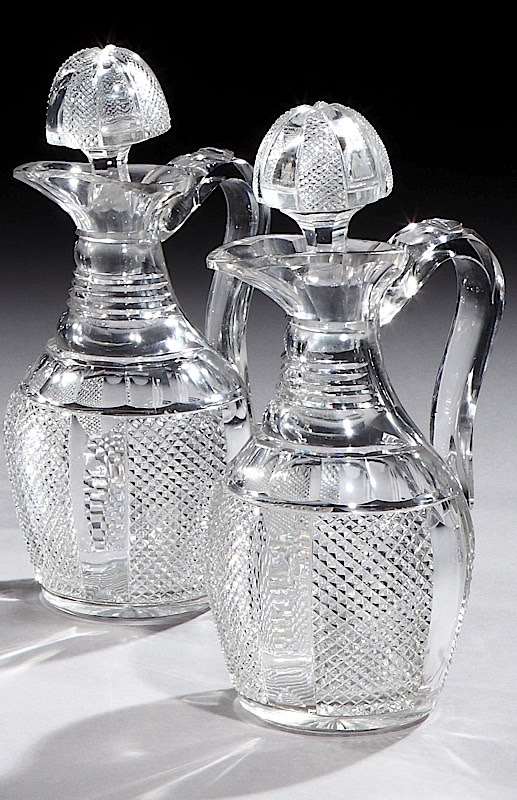 A PAIR OF VICTORIAN SILVER MOUNTED CUT GLASS CLARET JUGS